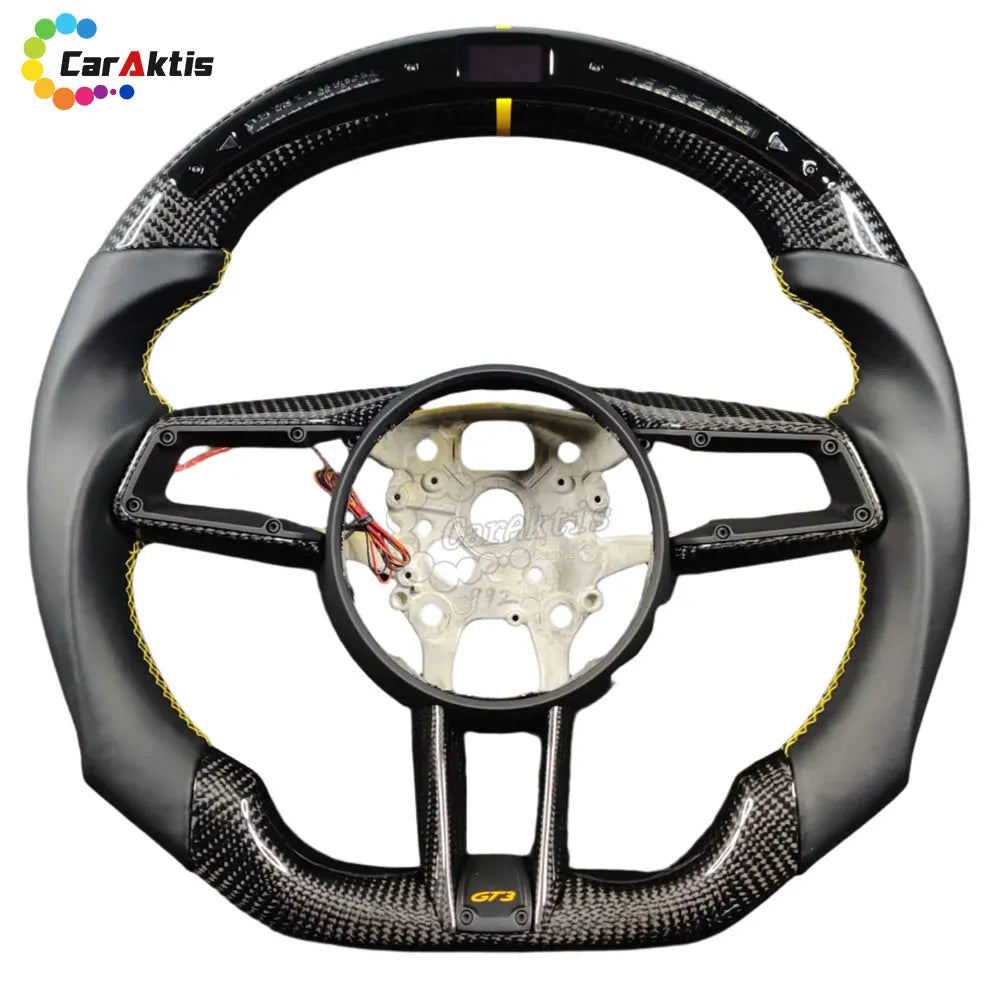 Custom Porsche 992 steering wheel with integrated LED performance display, shift lights, and carbon fiber finish.