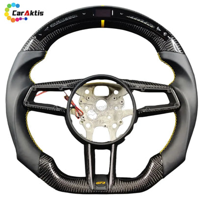 Custom Porsche 992 steering wheel with integrated LED performance display, shift lights, and carbon fiber finish.