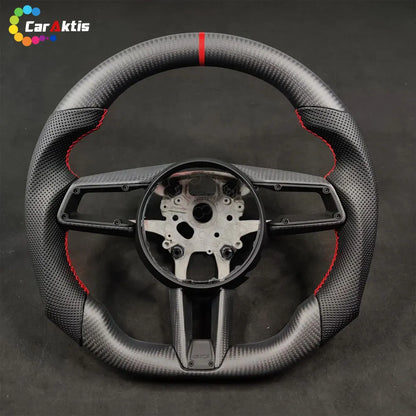 Bare core of a Porsche 992 custom carbon fiber steering wheel showing the internal structure and red center stripe.
