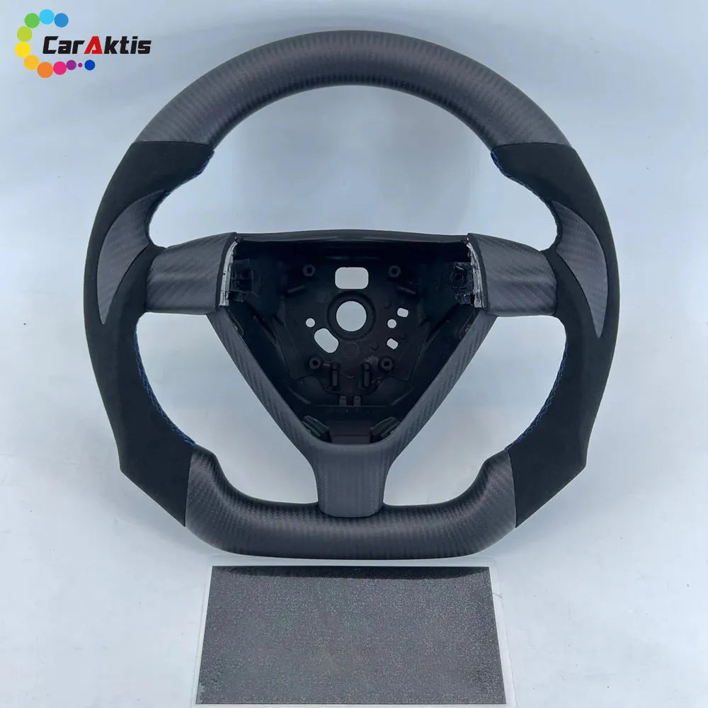 Forged carbon fiber steering wheel for Porsche 911 (993/996) with Alcantara side grips and sporty thumb rests.