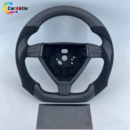 Forged carbon fiber steering wheel for Porsche 911 (993/996) with Alcantara side grips and sporty thumb rests.