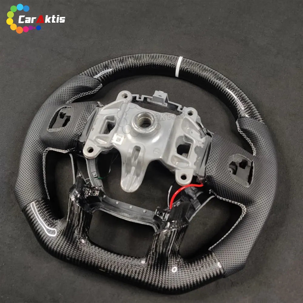 Rear view of a custom Ram steering wheel showing the OEM core structure, carbon fiber finish, and perforated leather stitching detail.