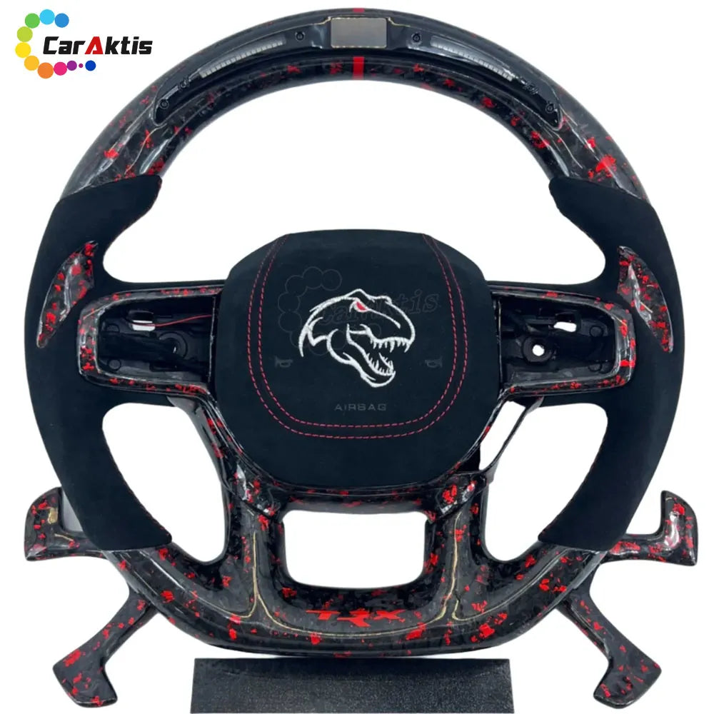 Black Alcantara custom steering wheel for Ram TRX with red forged carbon fiber accents and top LED display.