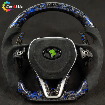 Close-up of unique blue forged carbon fiber finish with a high-gloss coating on a custom steering wheel.