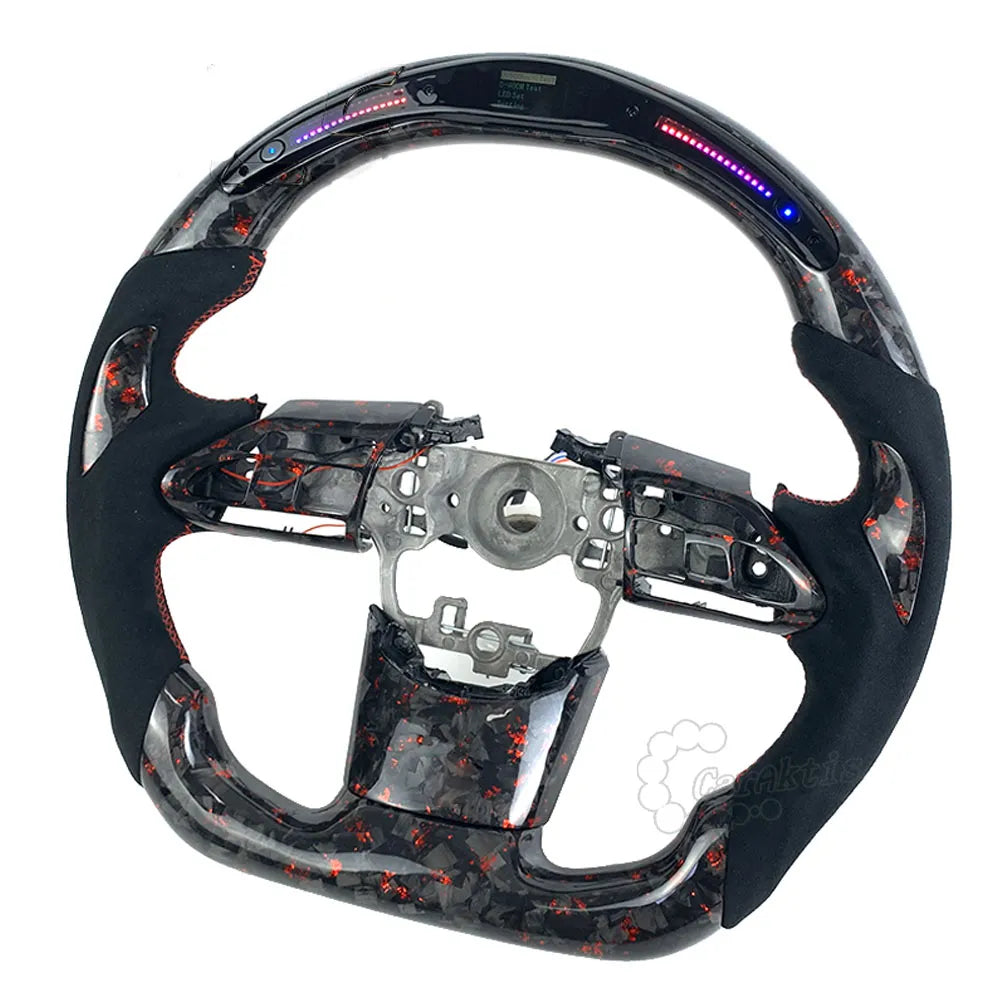 Upgraded carbon fiber steering wheel installed in a Toyota GR Supra A90 cockpit, showing a luxury racing interior look.