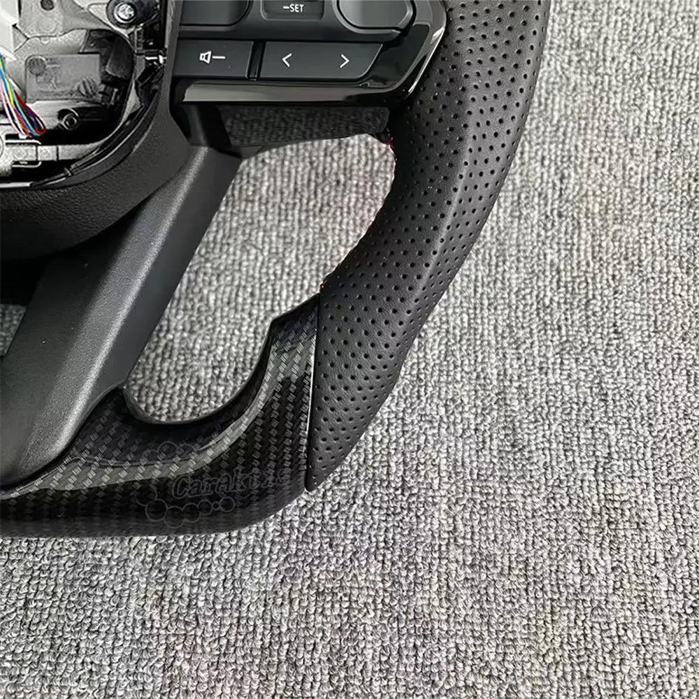 Close-up of premium black perforated leather on a Toyota Hilux steering wheel, showing breathable texture and handcrafted precision stitching for superior grip.