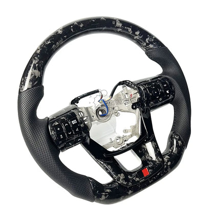 Premium forged carbon fiber steering wheel for Toyota Hilux with customized leather grips, luxury interior upgrade by Caraktis.