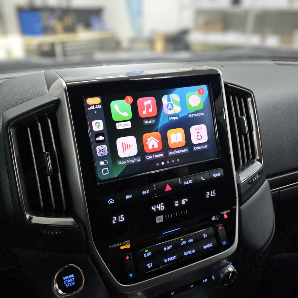 Close-up view of Apple CarPlay interface displayed on a Toyota Land Cruiser dashboard screen showing various iOS apps.