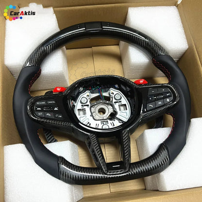 Flat bottom D-shape carbon fiber Custom Toyota Supra steering wheel with integrated LED performance shift lights and carbon fiber trim.