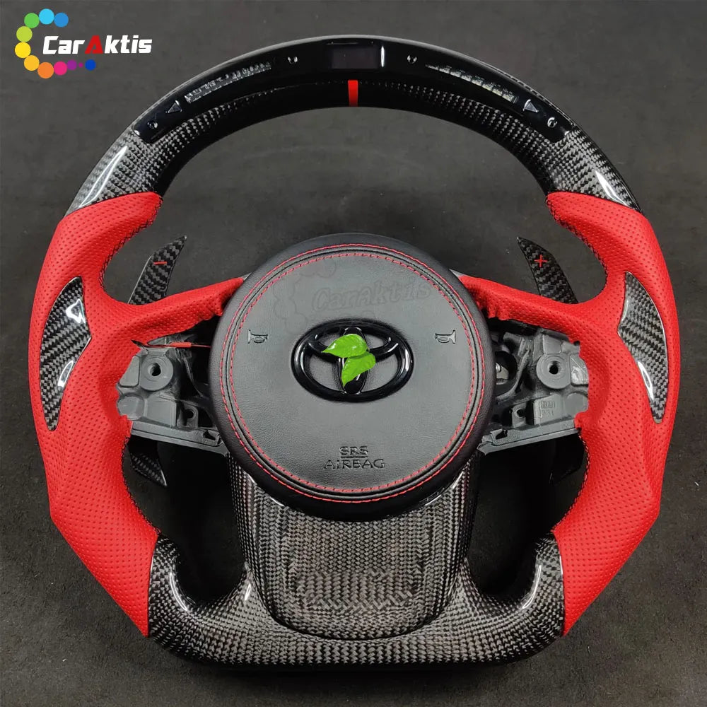 Custom Toyota Supra A90 carbon fiber steering wheel with integrated LED shift lights and real-time RPM performance display.