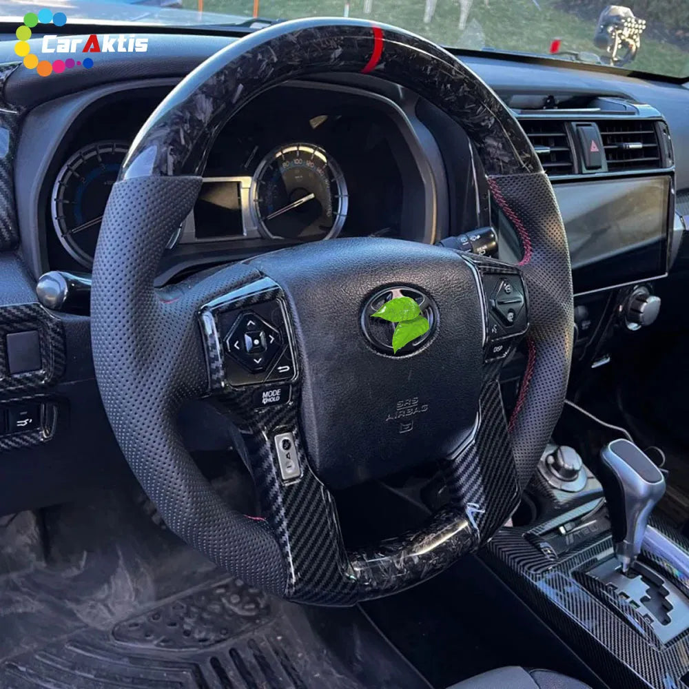 Installed view of a forged pattern carbon fiber steering wheel in a Toyota Tacoma.