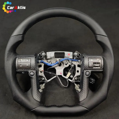 Ergonomic flat-bottom carbon fiber steering wheel designed for Toyota Tundra drivers.