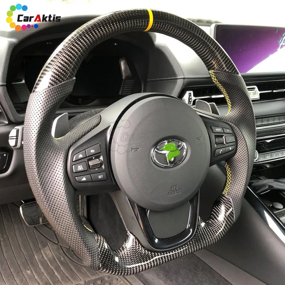 Track-ready Toyota GR86 interior setup featuring a D-shape carbon fiber and perforated leather wheel.