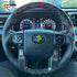 Close-up of a forged carbon fiber steering wheel with perforated leather installed in a Tundra.