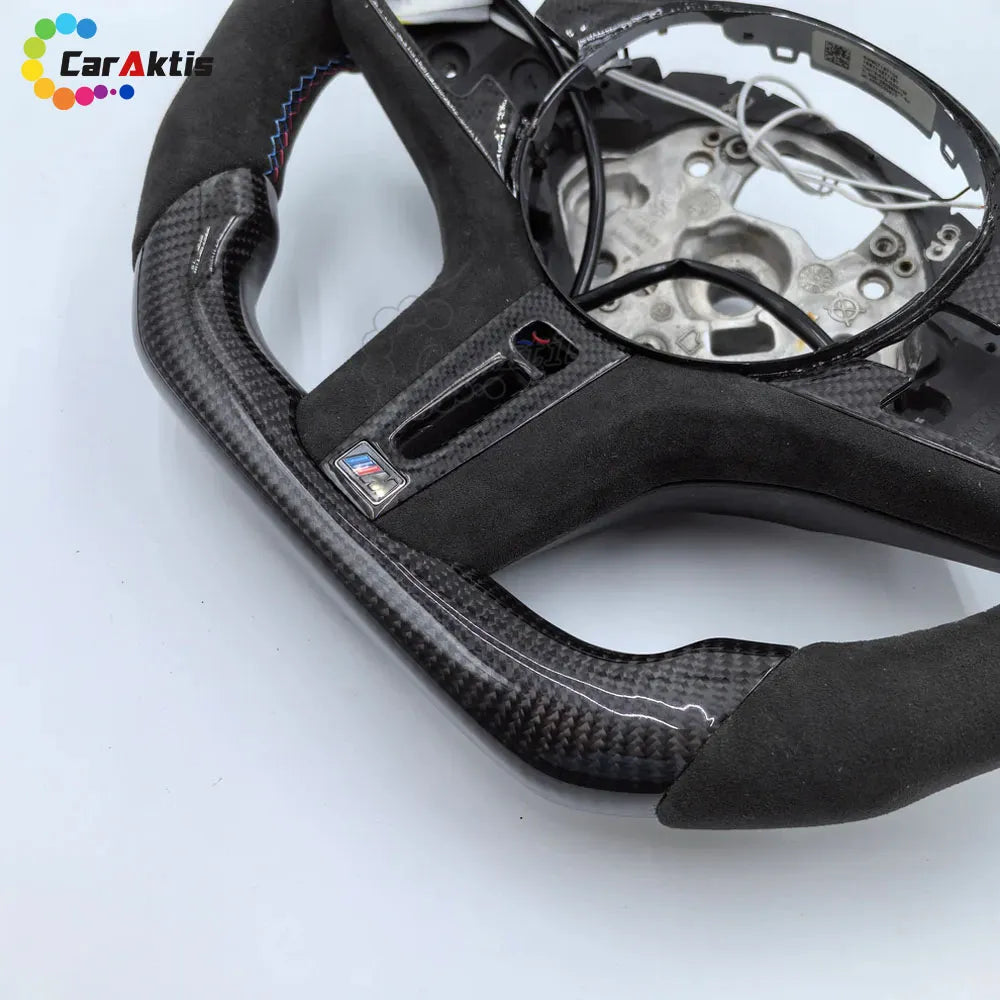 Premium perforated leather and 3K twill carbon fiber texture on BMW 3 Series steering wheel
