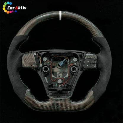 Premium matte carbon fiber steering wheel for Volvo S40 V50 featuring Alcantara suede grips and white center line.