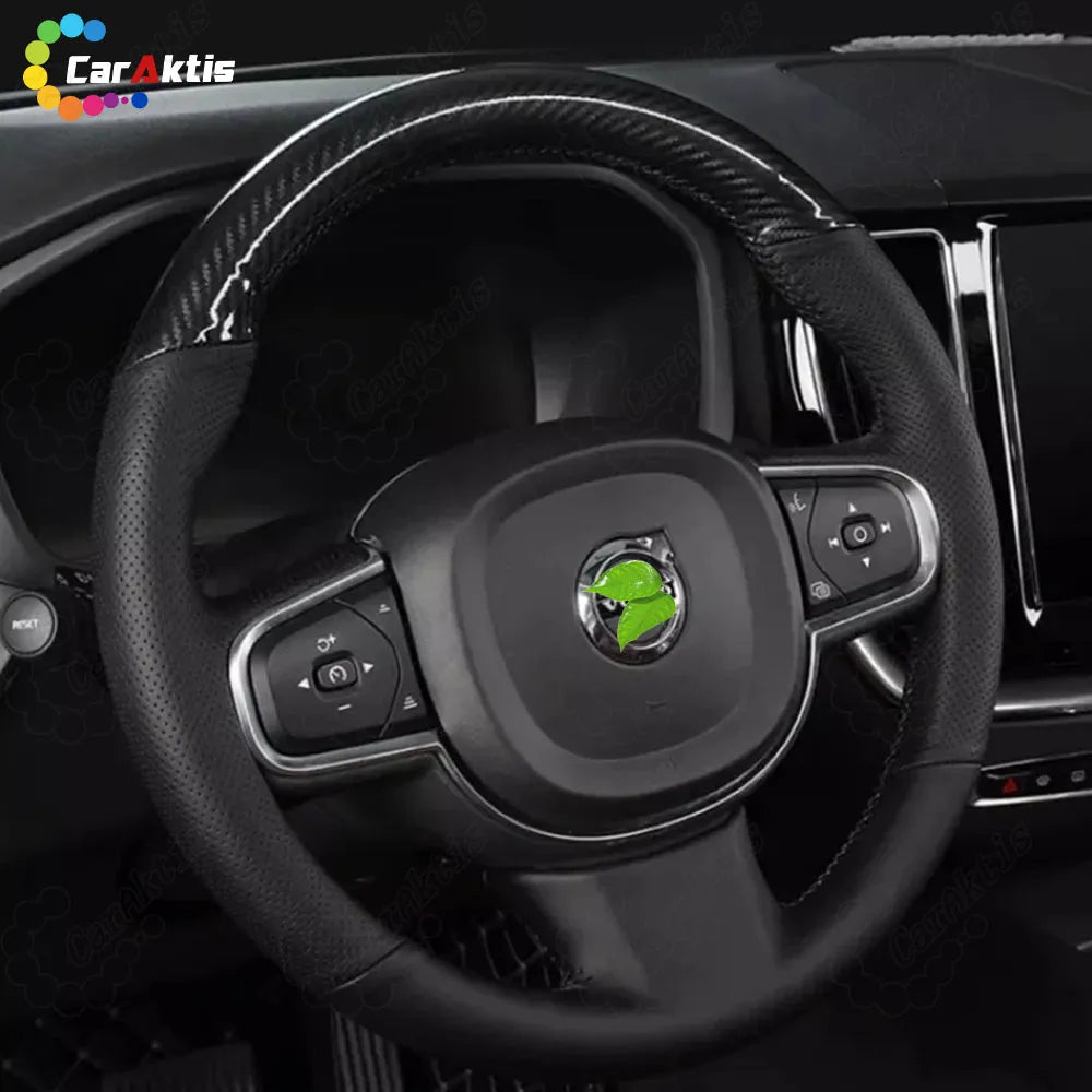 Interior view of a Volvo XC60 equipped with a glossy carbon fiber and leather steering wheel, showing airbag and button integration.