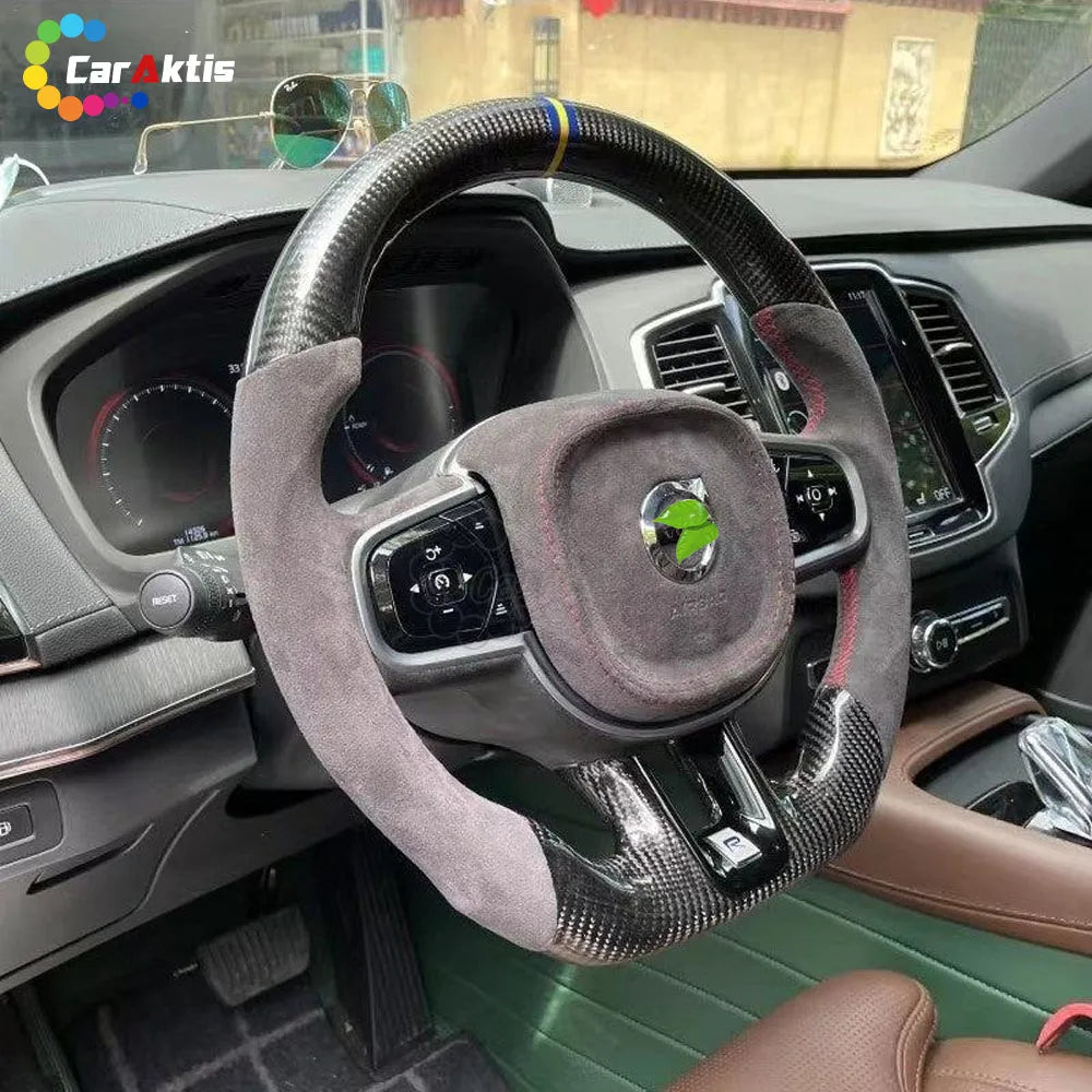 High-end Carbon Fiber Steering Wheel with Grey Alcantara and Red Stitching installed in a Volvo SUV.